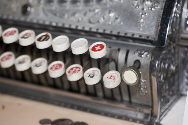 Close-up of levers on an antique cash register