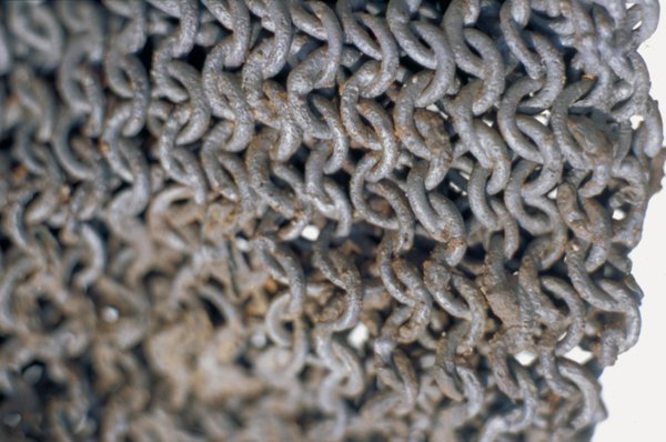 Close-up of chain mail armour, showing rust